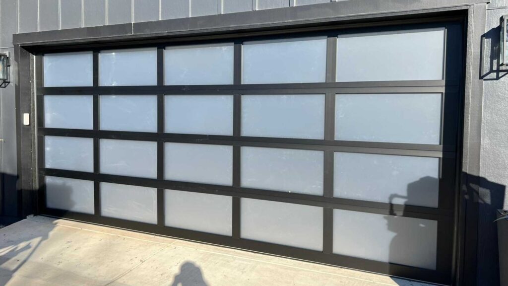 Black full-view garage door with frosted glass panels