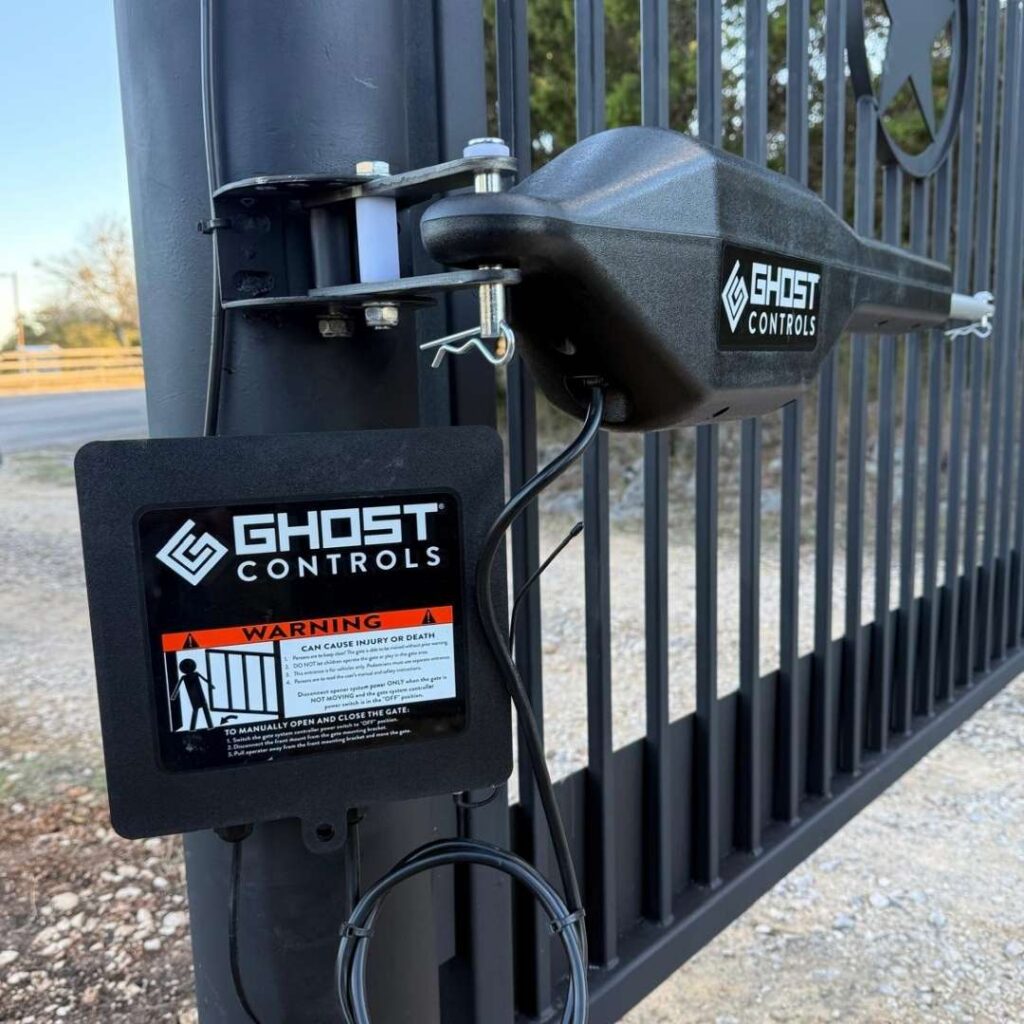 Swing gate opener mounted on a black metal gate