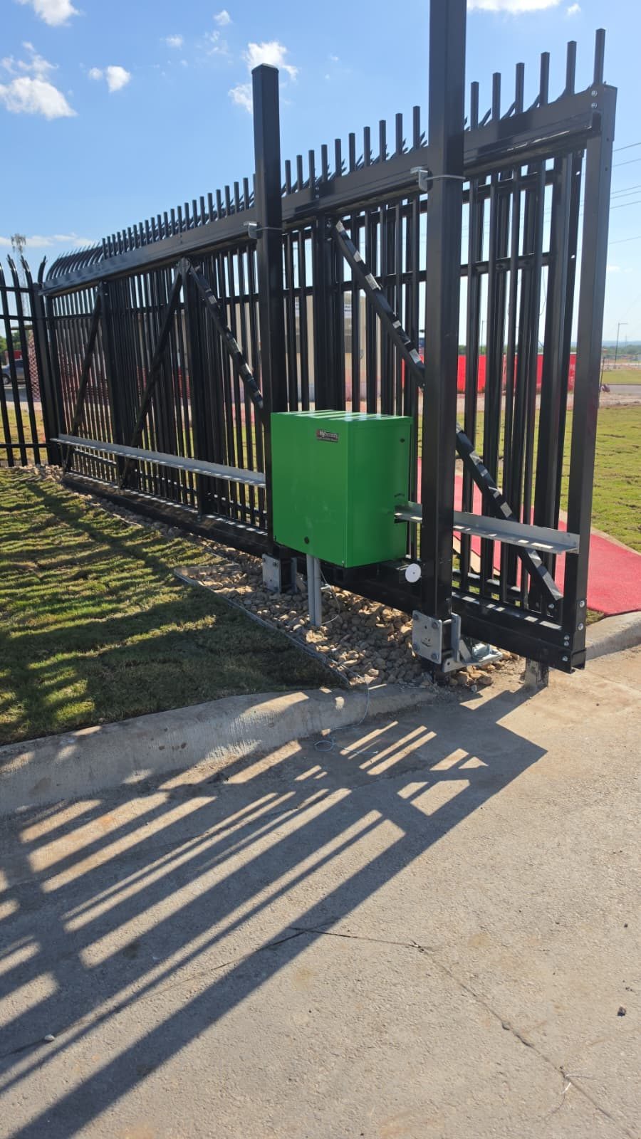 Commercial sliding gate with a gate operator installed by The Texas Garage Doors in San Marcos, TX